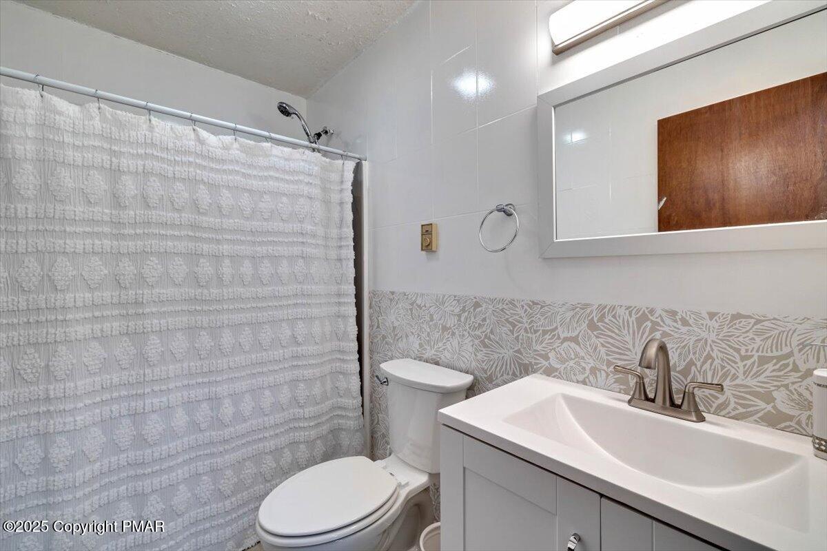 1662 Cotswald Road Tobyhanna, PA 18466 - Photo 16 of 43 a bathroom with a sink a toilet and mirror
