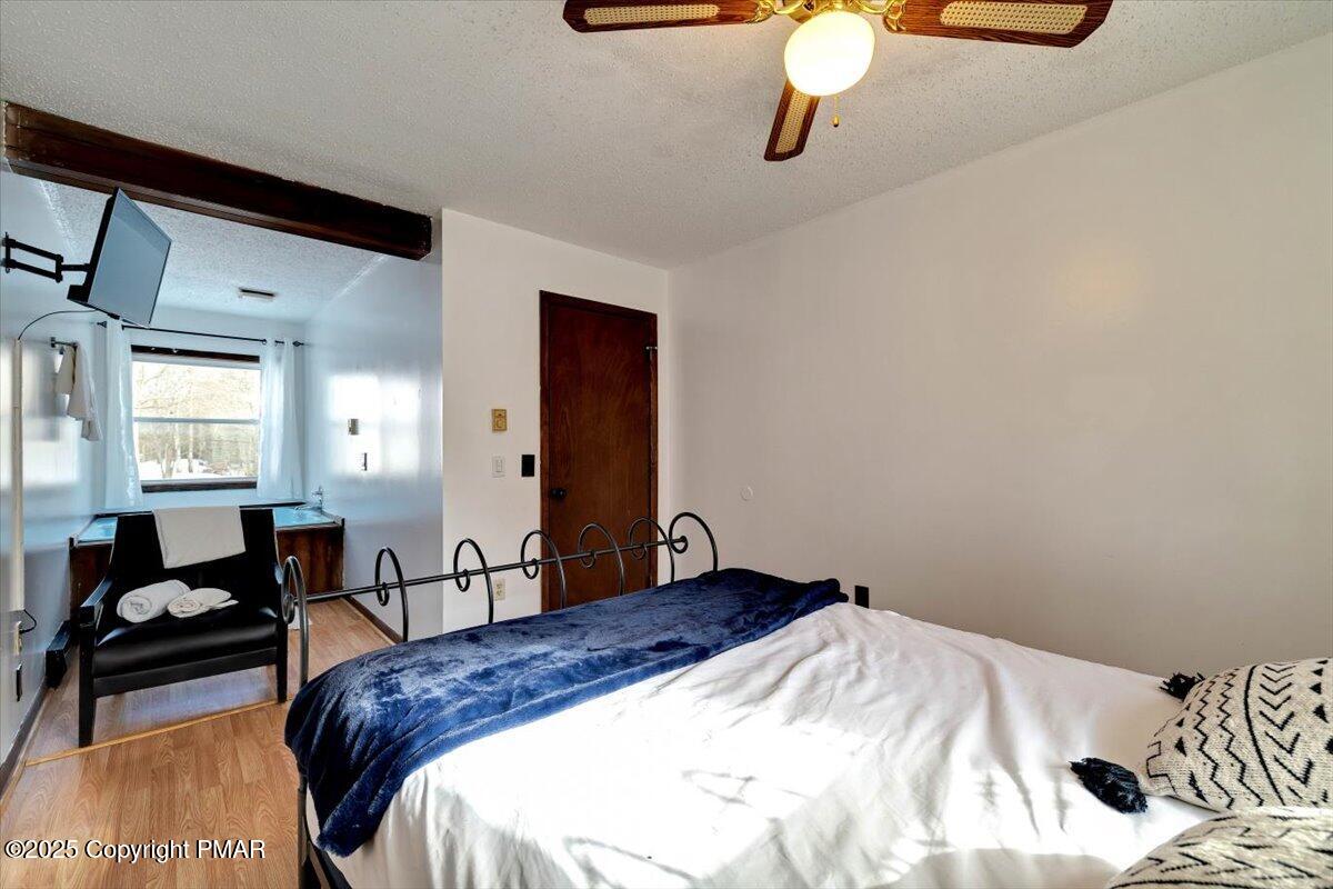 1662 Cotswald Road Tobyhanna, PA 18466 - Photo 18 of 43 a bedroom with a bed and wooden floor
