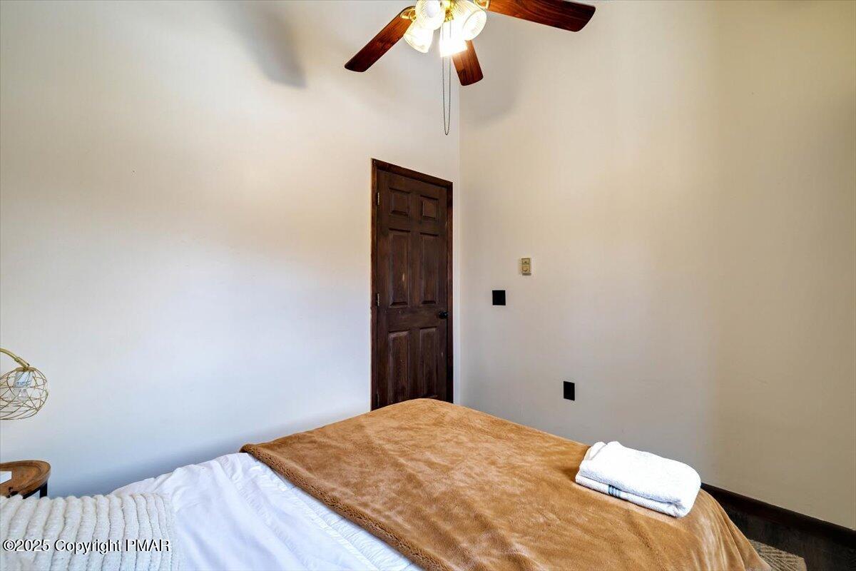 1662 Cotswald Road Tobyhanna, PA 18466 - Photo 22 of 43 a bedroom with a bed and a chandelier fan
