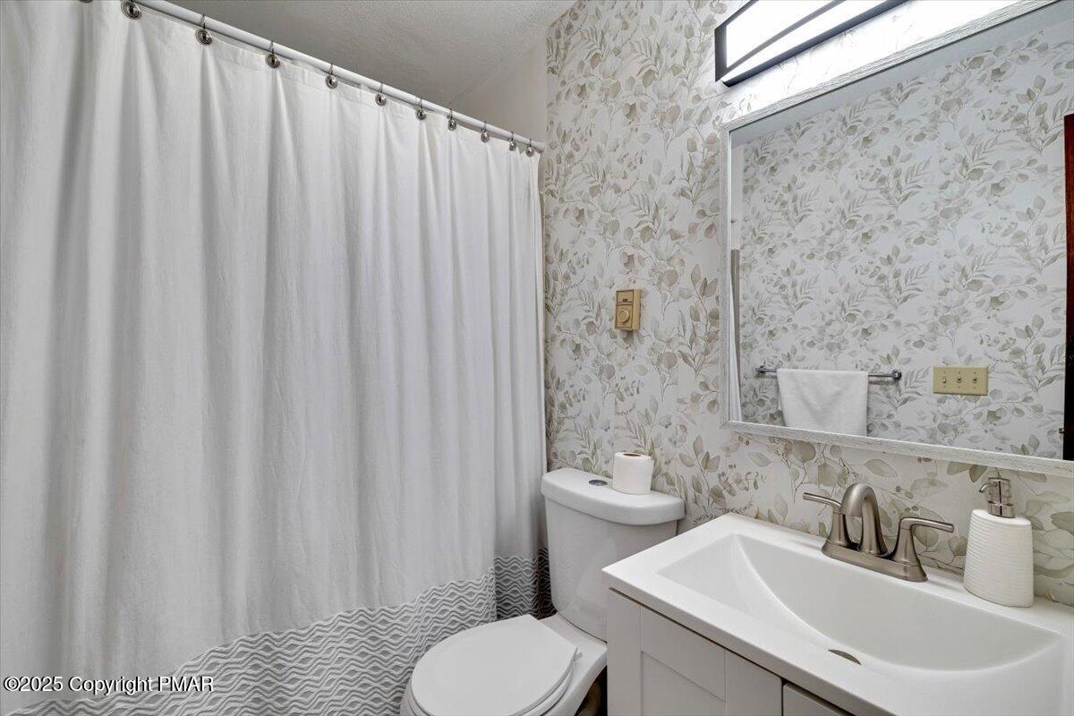 1662 Cotswald Road Tobyhanna, PA 18466 - Photo 23 of 43 a bathroom with a sink a toilet and shower curtain