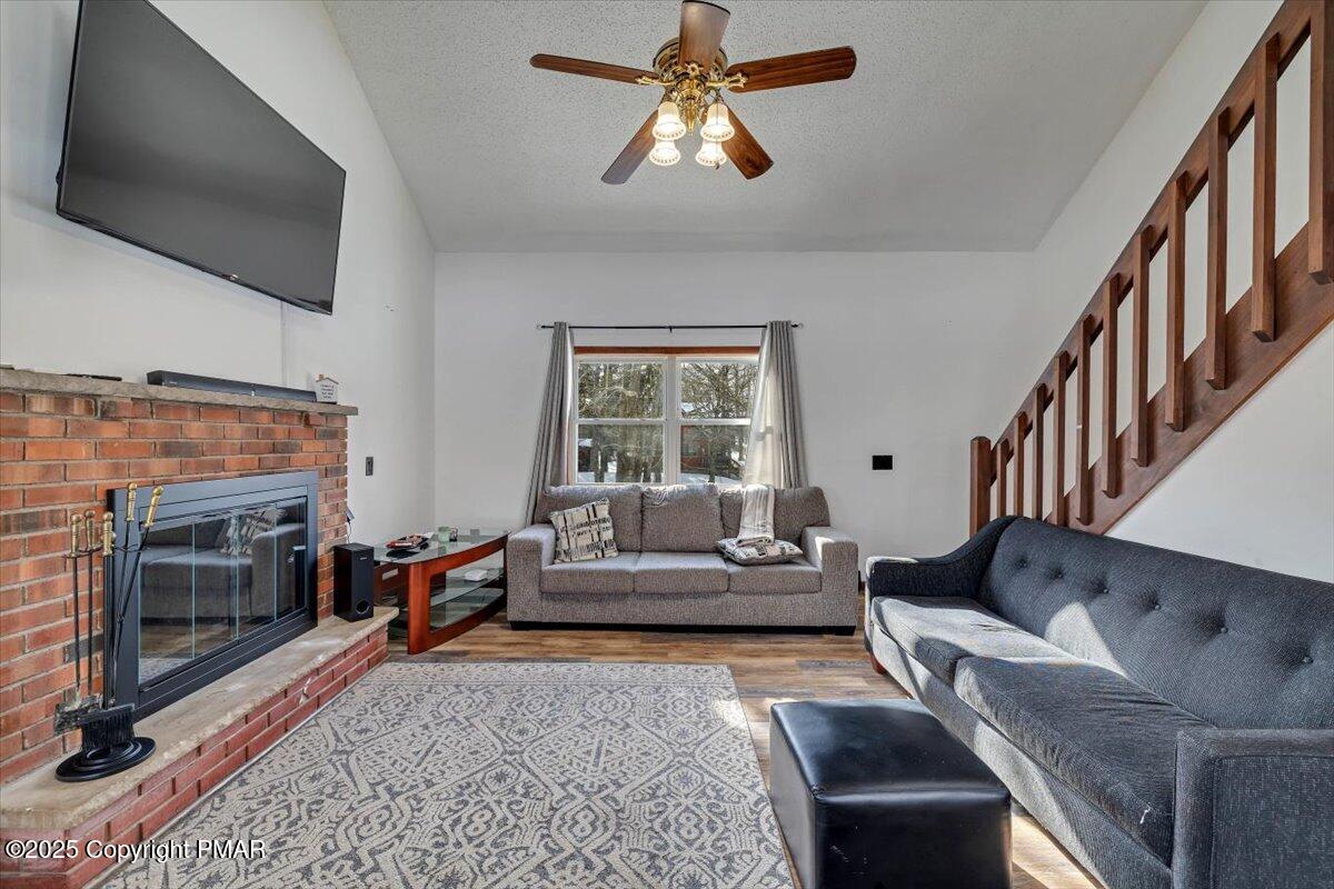 1662 Cotswald Road Tobyhanna, PA 18466 - Photo 9 of 43 a living room with furniture a flat screen tv and a fireplace