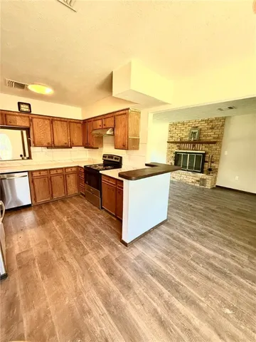 a view of a kitchen with kitchen island and a sink