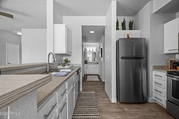 a kitchen with a refrigerator and a sink