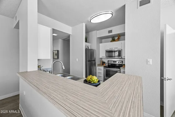 a kitchen with a refrigerator and a sink