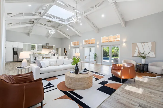 a living room with furniture and a chandelier
