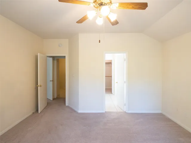 a view of a big room with a ceiling fan and a ceiling fan