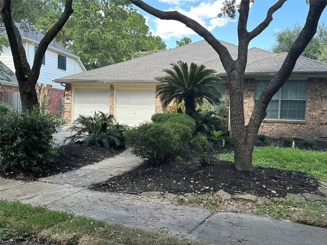 a front view of a house with yard and green space