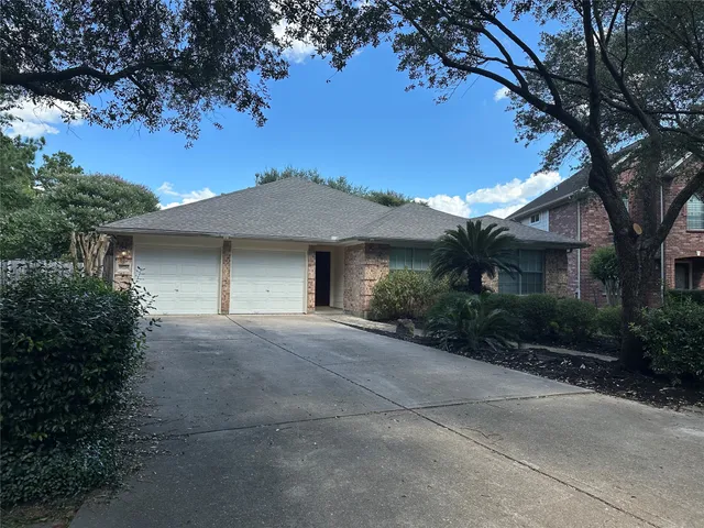 a view of a hallway with wooden floor and a staircase