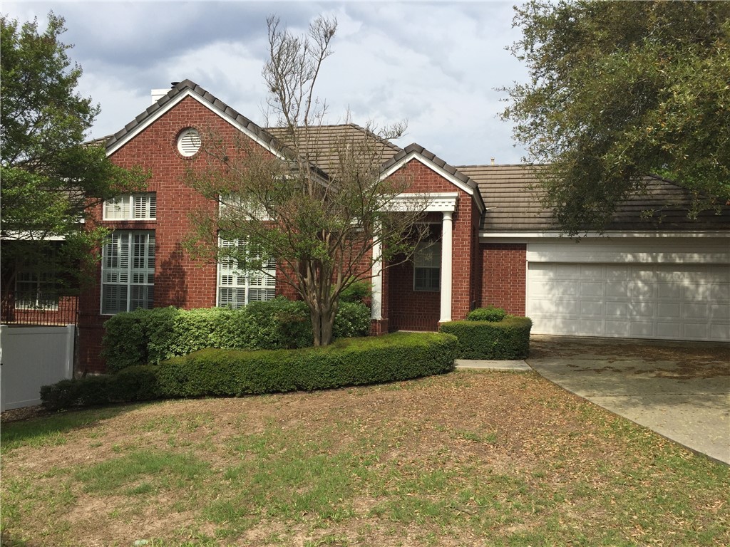 4010 Long Champ Drive, Unit 4 Austin, TX 78746 - Photo 1 of 1 a front view of a house with a yard and garage