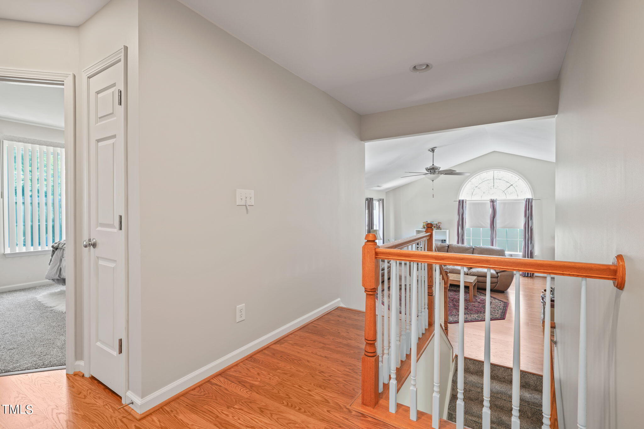 3509 Weir Way Raleigh, NC 27616 - Photo 18 of 52 a view of a hallway with wooden floor and stairs
