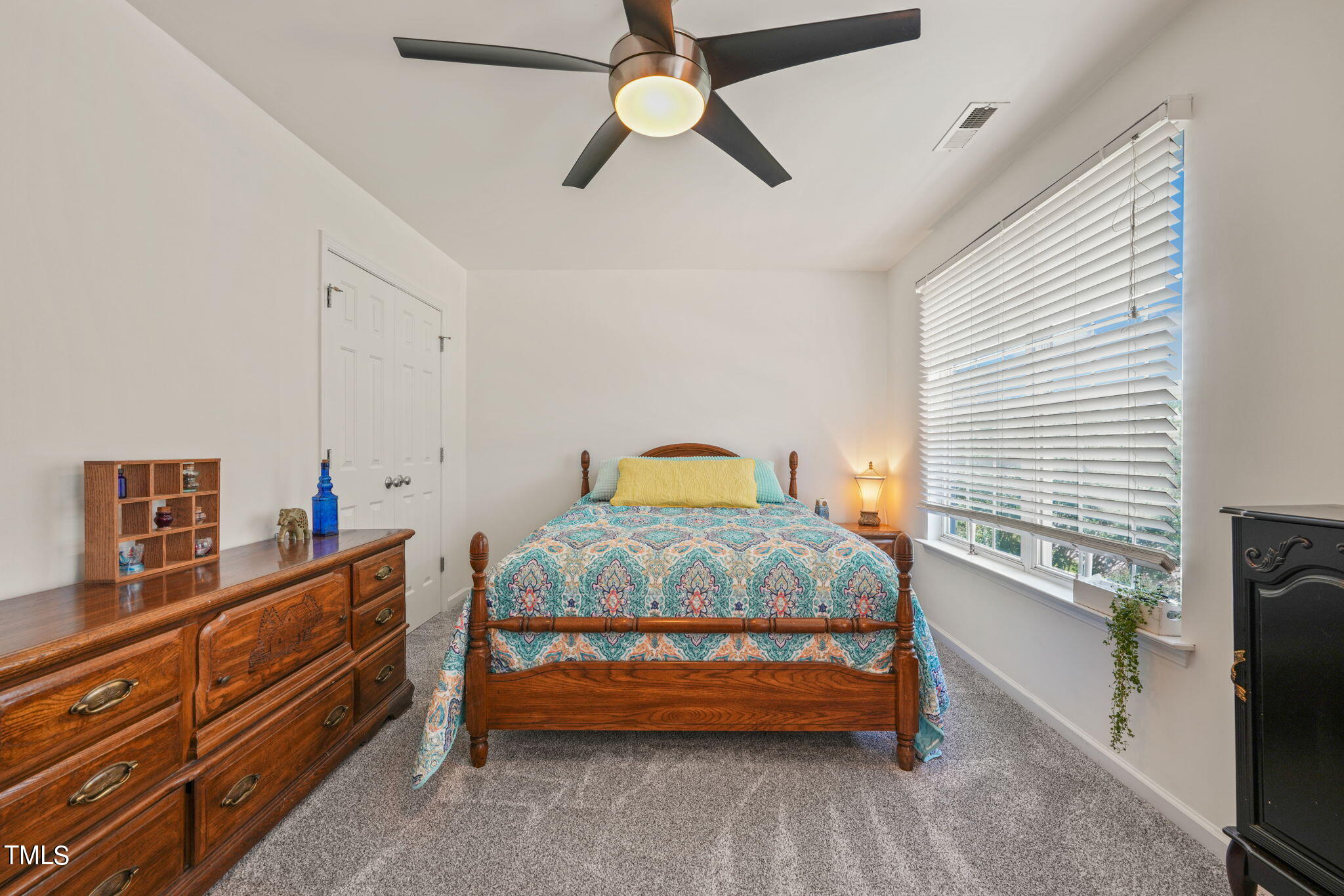 3509 Weir Way Raleigh, NC 27616 - Photo 30 of 52 a bedroom with a bed and a chandelier fan