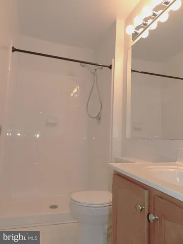 a bathroom with a shower a toilet and sink