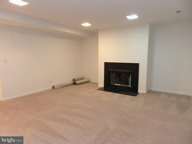 a view of empty room with a fireplace