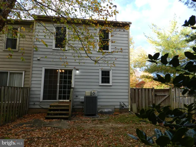 a view of a house with a yard and wooden fence