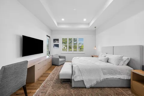 a bedroom with a bed and a flat screen tv