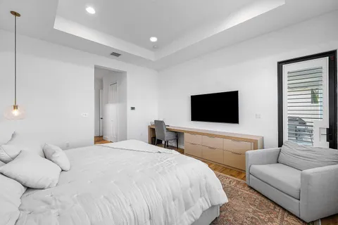 a bedroom with a bed and a flat screen tv