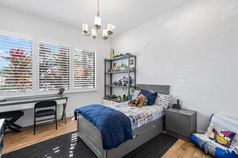 a bedroom with a bed and a chandelier