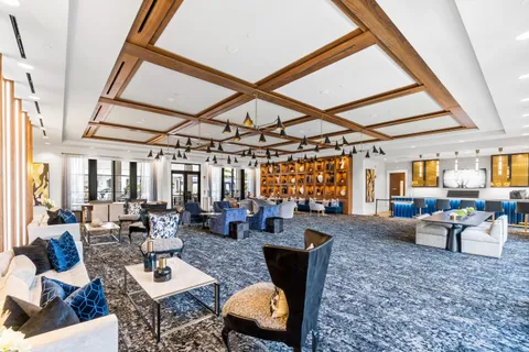 a living room with furniture and large windows