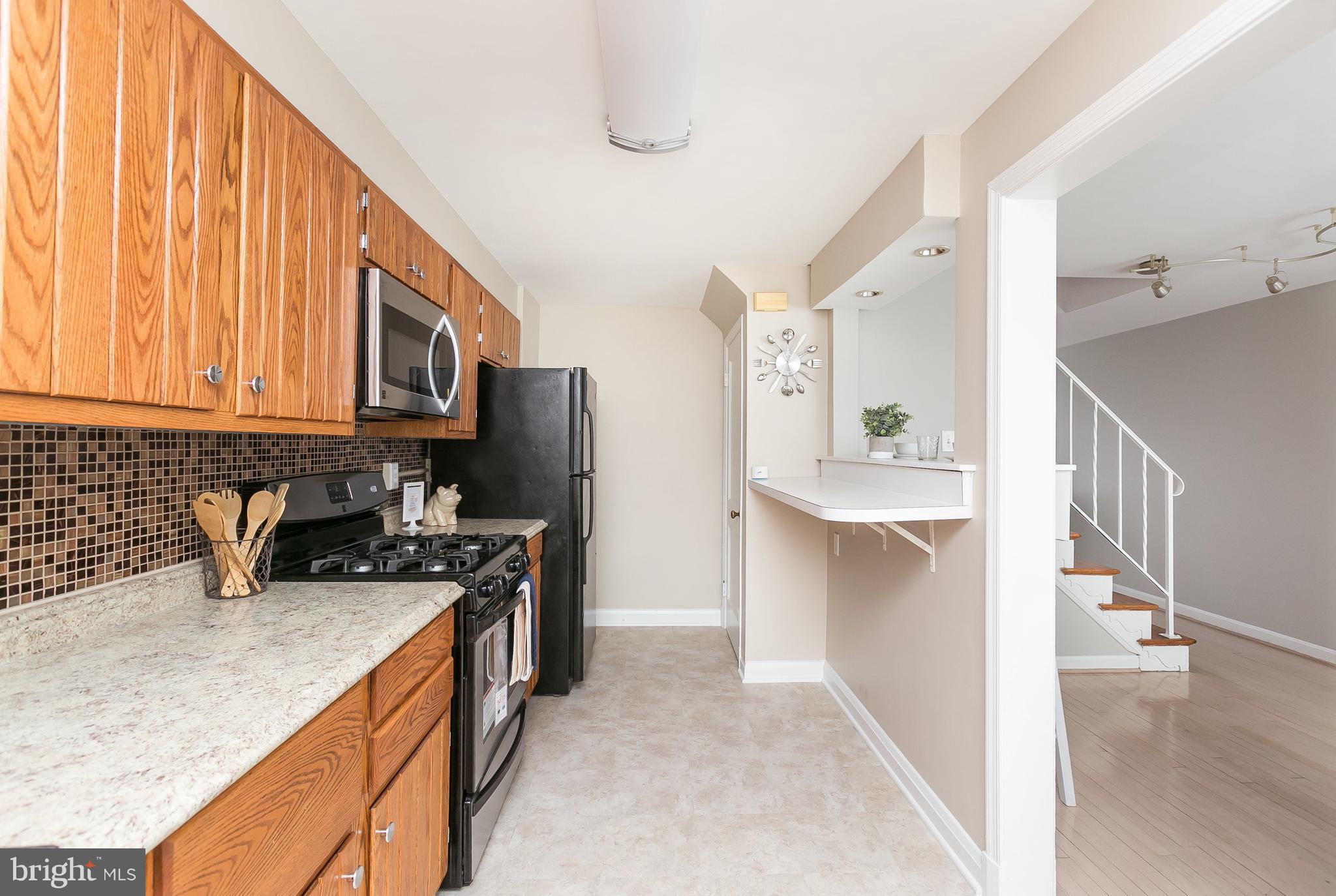 1504 Clairidge Road Baltimore, MD 21207 - Photo 11 of 30 a kitchen with stainless steel appliances granite countertop a refrigerator stove and sink