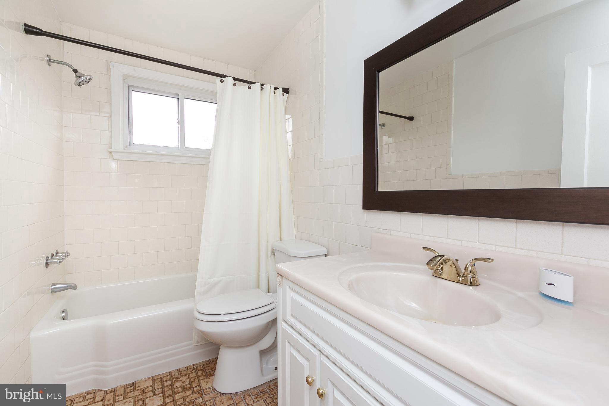 1504 Clairidge Road Baltimore, MD 21207 - Photo 20 of 30 a bathroom with a sink toilet and shower