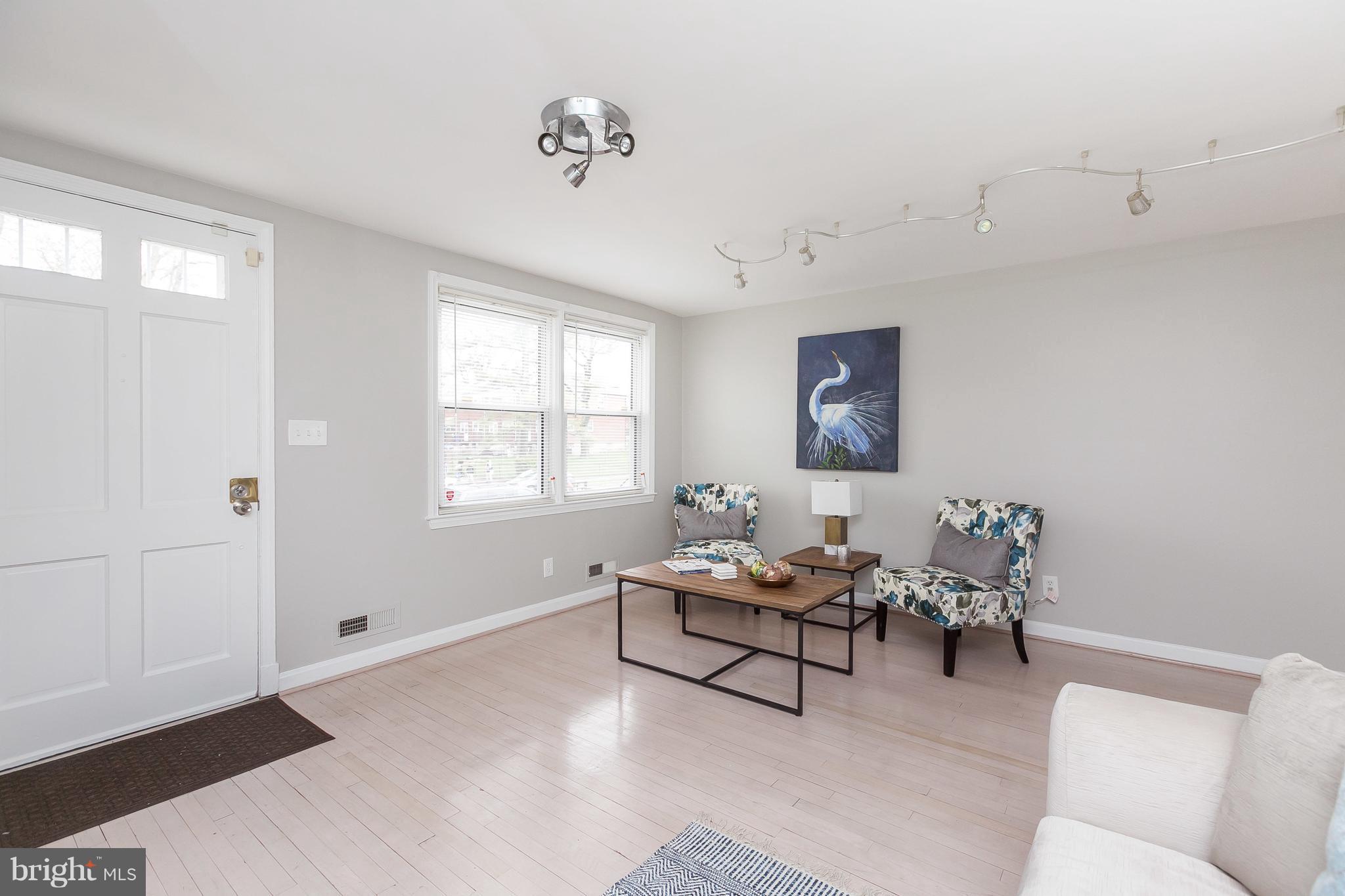 1504 Clairidge Road Baltimore, MD 21207 - Photo 3 of 30 a living room with furniture and wooden floor