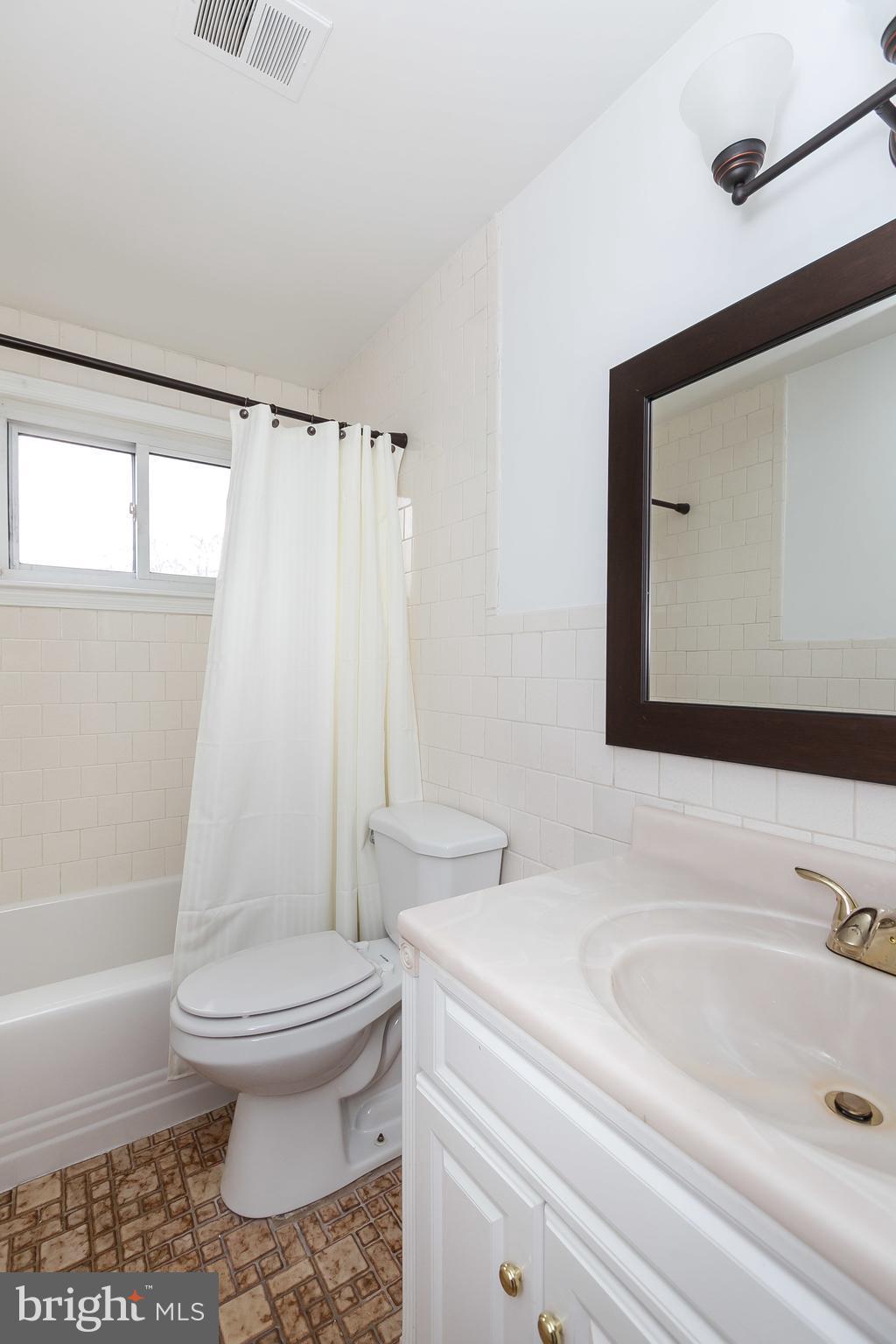 1504 Clairidge Road Baltimore, MD 21207 - Photo 21 of 30 a bathroom with a sink toilet and shower