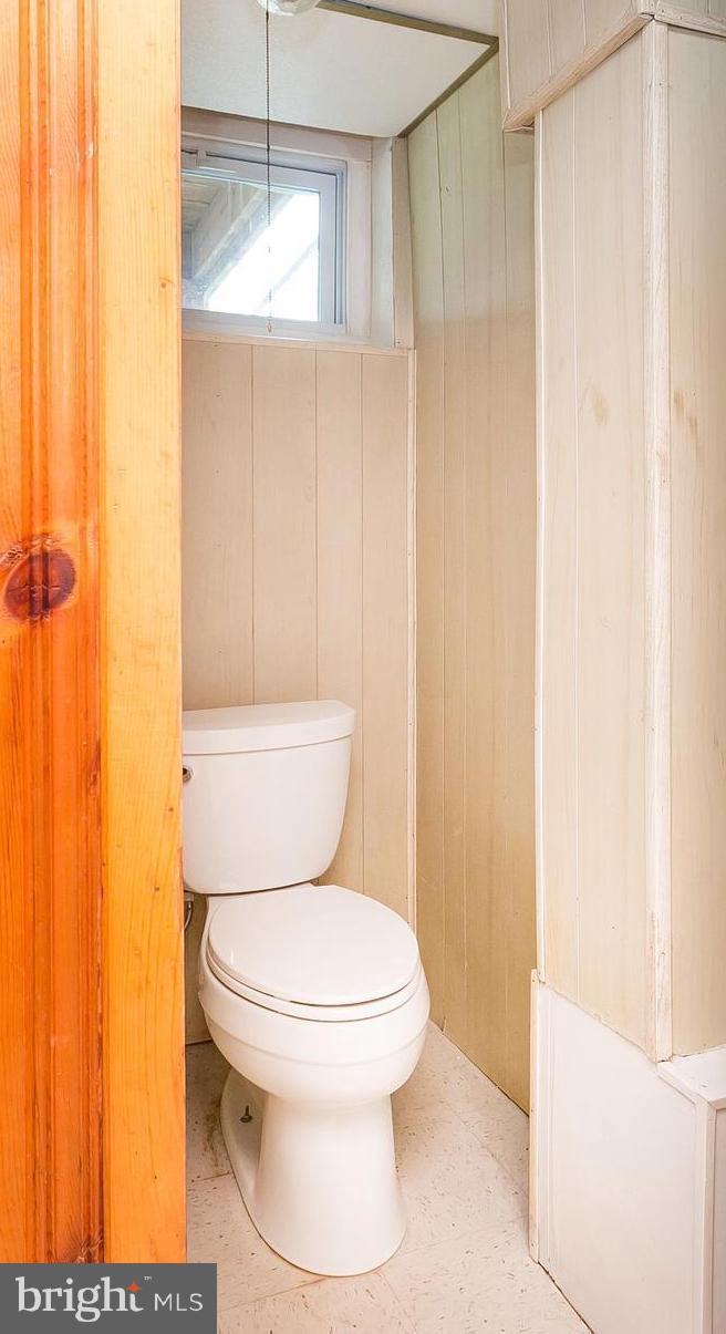 1504 Clairidge Road Baltimore, MD 21207 - Photo 24 of 30 a white toilet sitting next to a shower curtain