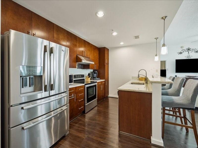 5925 Almeda Road, Unit 11901 Houston, TX 77004 - Photo 2 of 36 Designed for both functionality and style, the chef-inspired kitchen features sleek stainless-steel appliances, abundant cabinetry, marble countertops, and a large center island with seating.