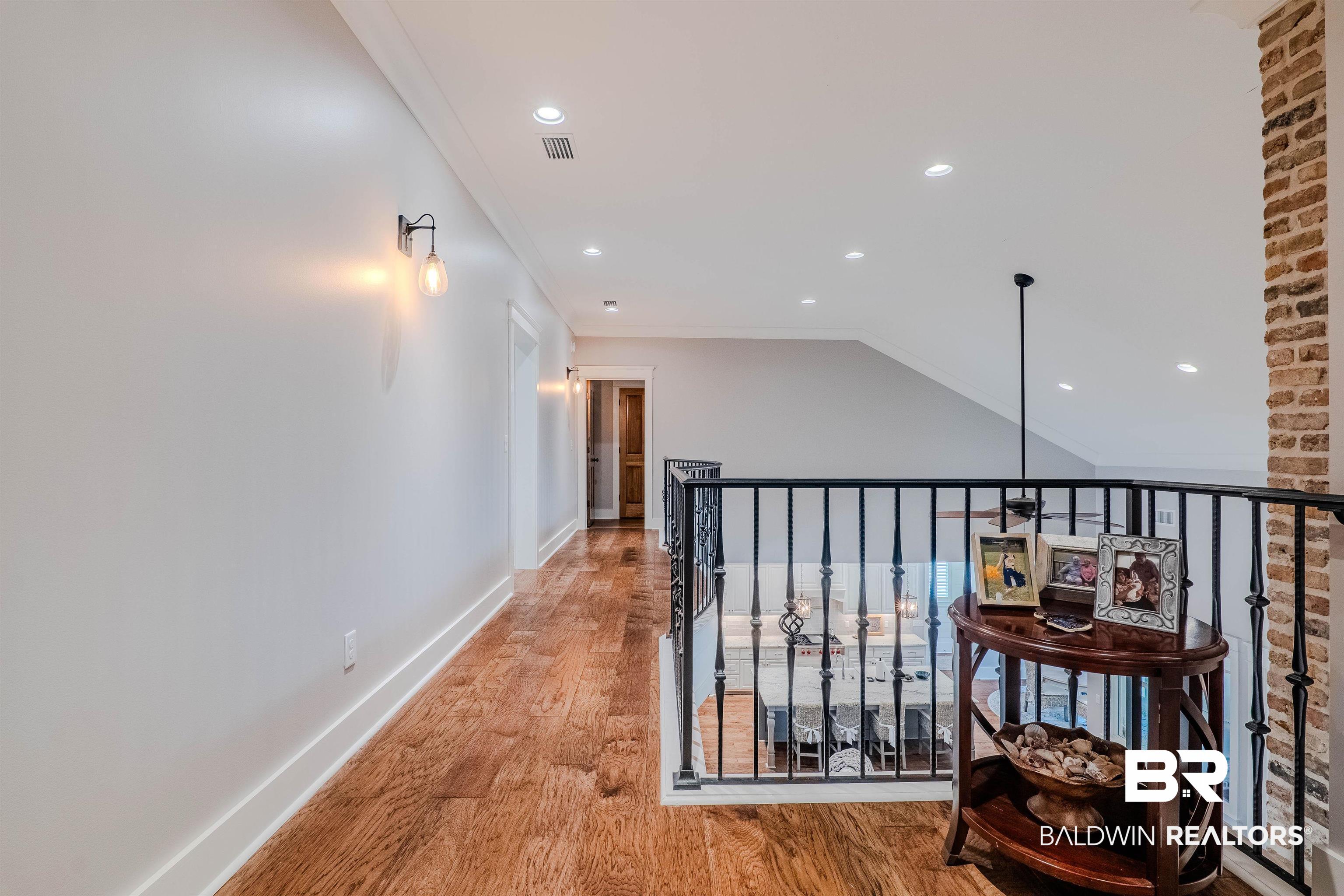 708 Manning Place Fairhope, AL 36532 - Photo 36 of 58 Corridor with light hardwood / wood-style flooring, ornamental molding, and vaulted ceiling
