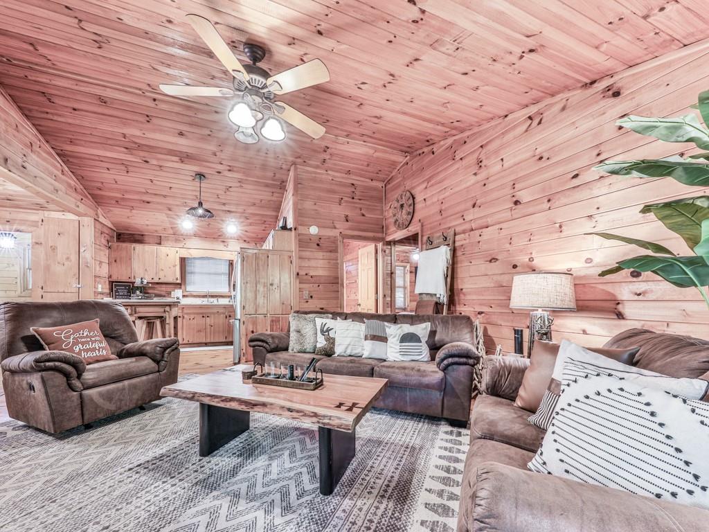 189 Smith Hill Road Blue Ridge, GA 30513 - Photo 15 of 29 a living room with lots of furniture and a chandelier