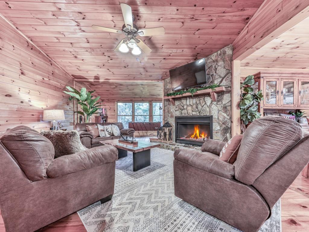189 Smith Hill Road Blue Ridge, GA 30513 - Photo 7 of 29 a living room with furniture a fireplace and a table