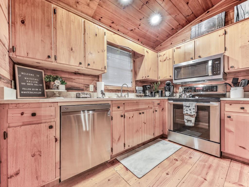189 Smith Hill Road Blue Ridge, GA 30513 - Photo 10 of 29 a kitchen with stainless steel appliances granite countertop a stove sink and cabinets