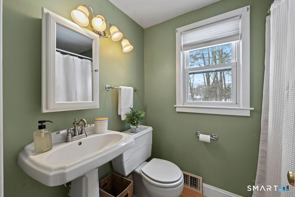 9 Barry Lane Simsbury, CT 06070 - Photo 18 of 28 a bathroom with a toilet a sink and mirror