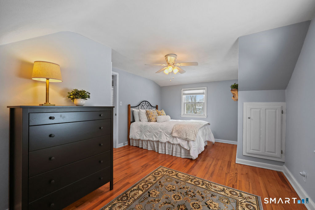 9 Barry Lane Simsbury, CT 06070 - Photo 22 of 28 a bedroom with a bed and wooden floor
