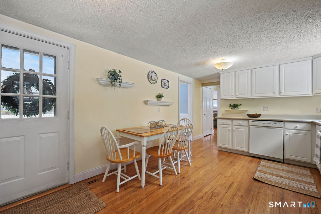 9 Barry Lane Simsbury, CT 06070 - Photo 6 of 28 a kitchen with stainless steel appliances a dining table chairs and granite counter tops