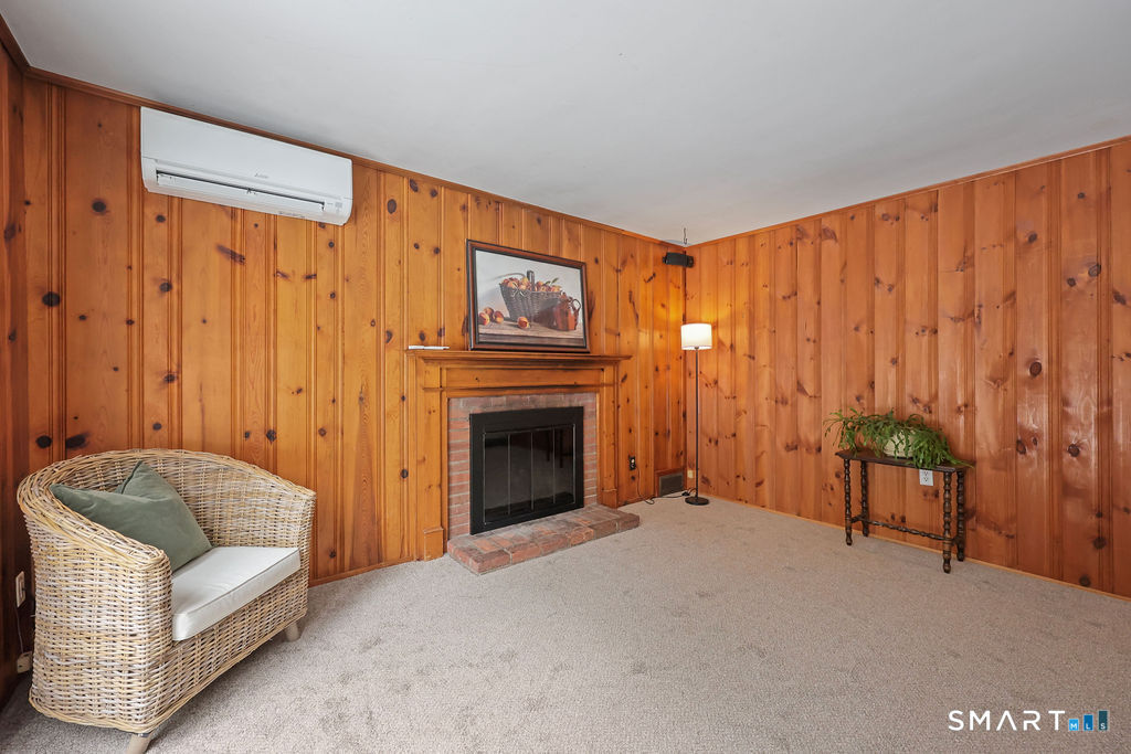 9 Barry Lane Simsbury, CT 06070 - Photo 10 of 28 a living room with furniture a fireplace and a window