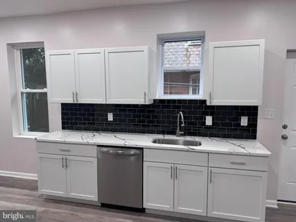 a kitchen with white cabinets