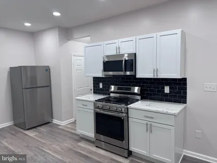 a kitchen with a stove and a microwave