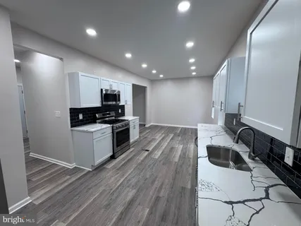 a kitchen with granite countertop a stove and a sink