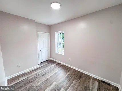 a view of room with window and hardwood floor