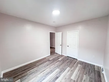 a view of a room with wooden floor
