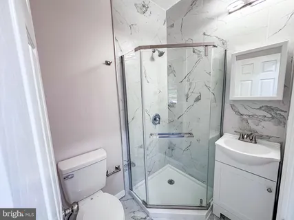 a white toilet sitting next to a bathroom sink
