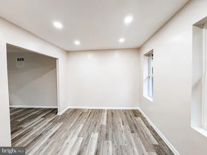 a view of room with window and wooden floor