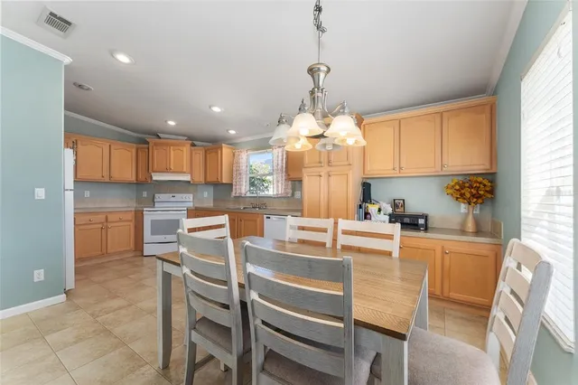 a kitchen with kitchen island dining table and stainless steel appliances