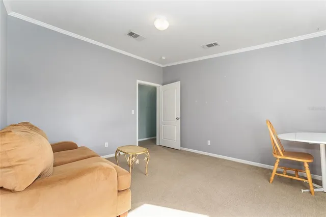 a bedroom with a bed and a chair