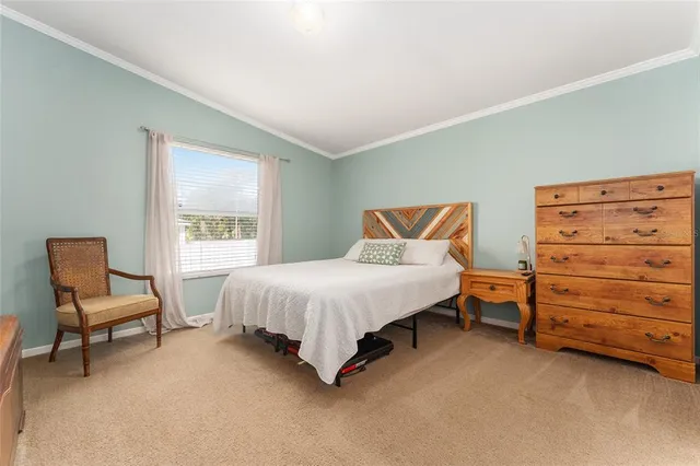 a bedroom with a bed and chair