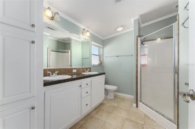 a bathroom with a granite countertop sink mirror and toilet