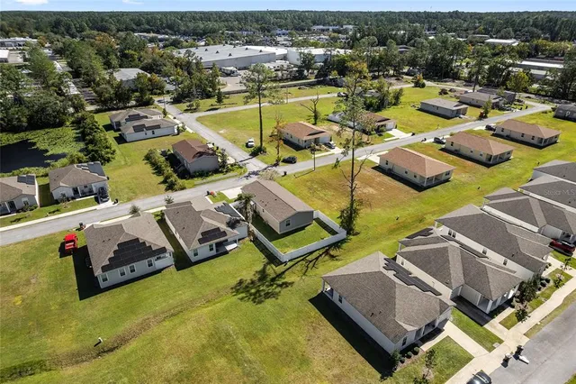 an aerial view of a house with a swimming pool