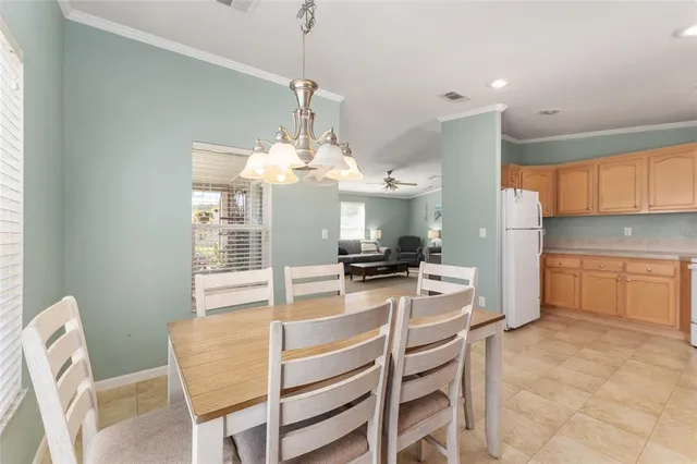 a view of a dining room with furniture and chandelier