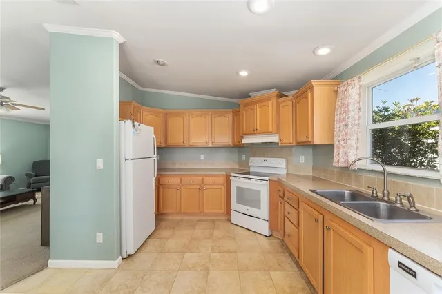 a kitchen with stainless steel appliances granite countertop a refrigerator and sink
